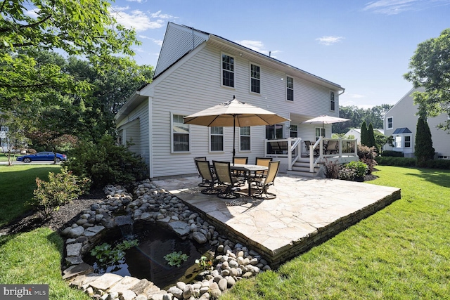 1839 Disney Estates Cir, Severn, MD 21144 - back of property with a patio, a yard, and a wooden deck