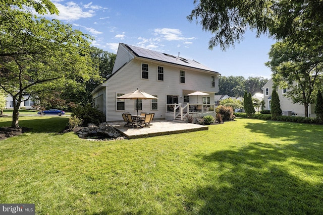 1839 Disney Estates Cir, Severn, MD 21144 - rear view of property with solar panels, a patio area, and a yard
