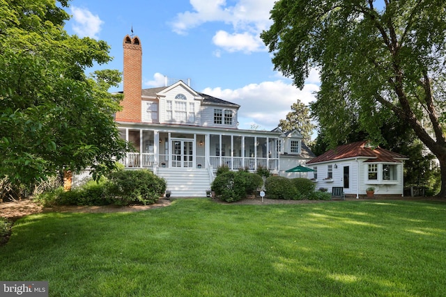 1241 Cherry Tree Ln, Annapolis, MD 21403 - back of house featuring a sunroom, a yard, and a chimney