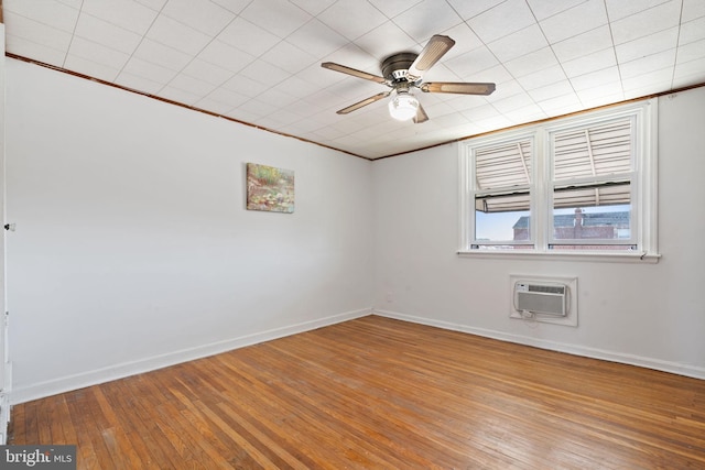 6602 Revere St, Philadelphia, PA 19149 - spare room featuring a wall mounted air conditioner, a ceiling fan, hardwood / wood-style flooring, baseboards, and crown molding
