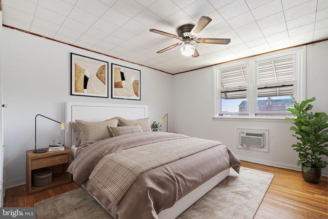 6602 Revere St, Philadelphia, PA 19149 - bedroom with a wall mounted air conditioner, wood finished floors, ornamental molding, baseboards, and ceiling fan