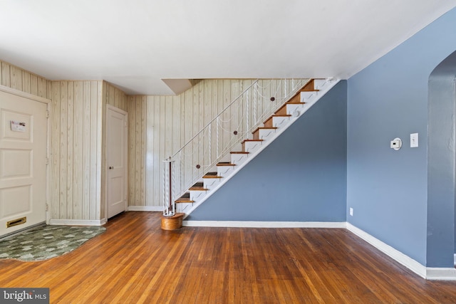 6602 Revere St, Philadelphia, PA 19149 - stairway featuring arched walkways, wood finished floors, and baseboards