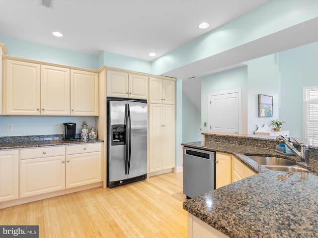 32561 Heron Cir Unit 13, Bethany Beach, DE 19930 - kitchen with stainless steel appliances, a sink, light wood finished floors, dark stone counters, and recessed lighting