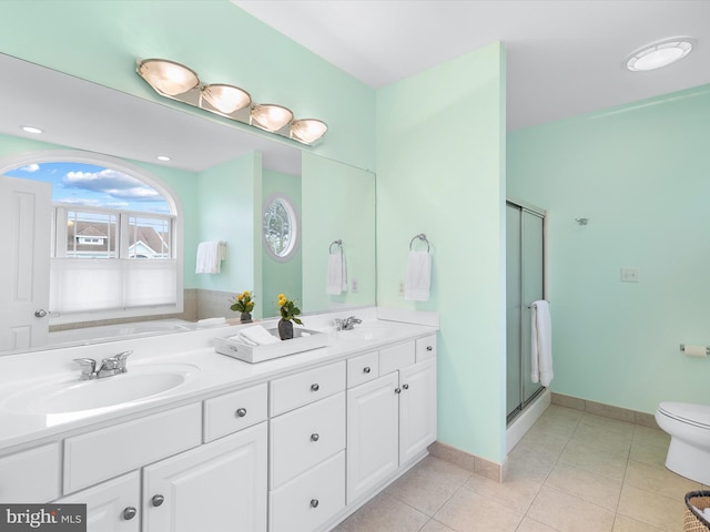 32561 Heron Cir Unit 13, Bethany Beach, DE 19930 - bathroom featuring double vanity, a stall shower, toilet, tile patterned floors, and baseboards