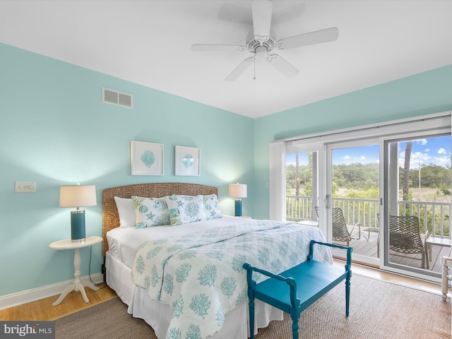 32561 Heron Cir Unit 13, Bethany Beach, DE 19930 - bedroom featuring multiple windows, access to exterior, wood finished floors, and baseboards