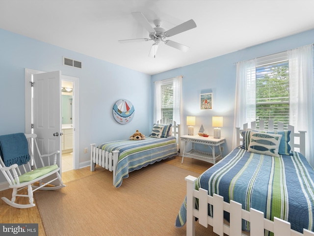32561 Heron Cir Unit 13, Bethany Beach, DE 19930 - bedroom with wood finished floors, a ceiling fan, and ensuite bathroom