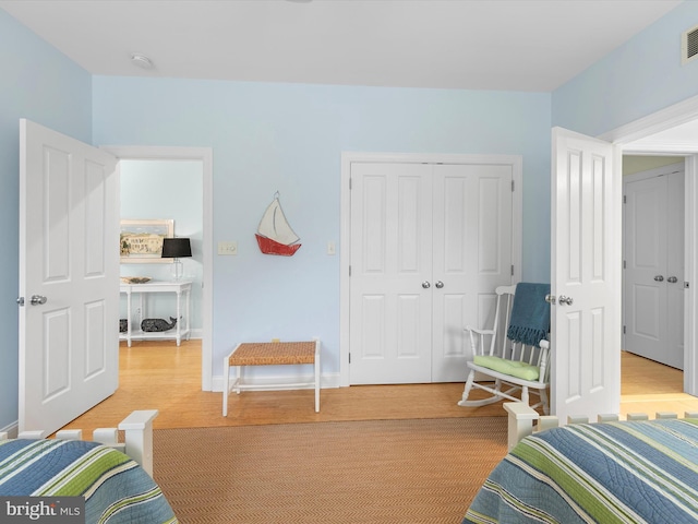 32561 Heron Cir Unit 13, Bethany Beach, DE 19930 - bedroom featuring light wood-type flooring, a closet, and baseboards