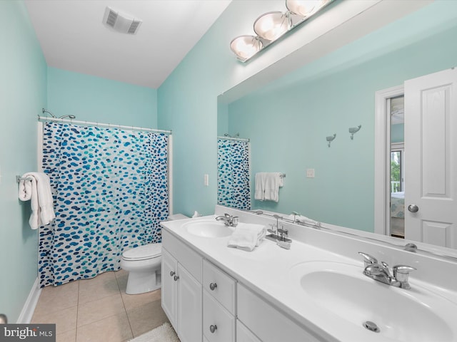 32561 Heron Cir Unit 13, Bethany Beach, DE 19930 - bathroom featuring toilet, double vanity, tile patterned floors, and curtained shower