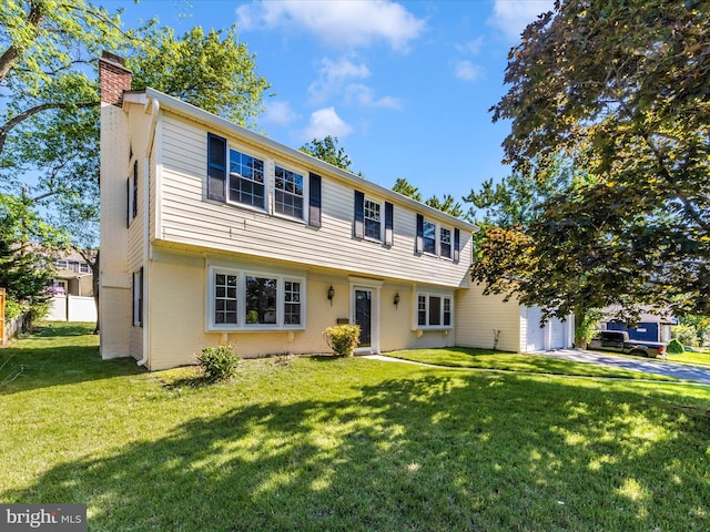 colonial house featuring a chimney, an attached garage, concrete driveway, and brick siding