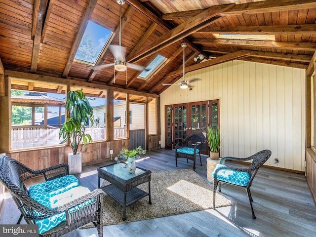 sunroom featuring french doors and a skylight