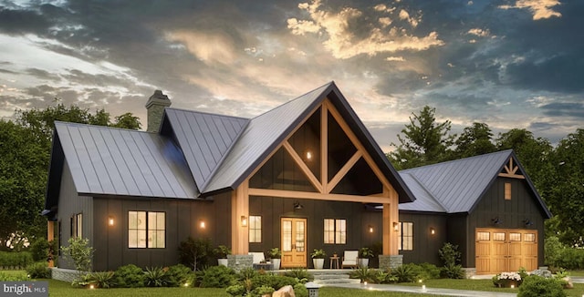 view of front of house with a standing seam roof, an attached garage, metal roof, and board and batten siding