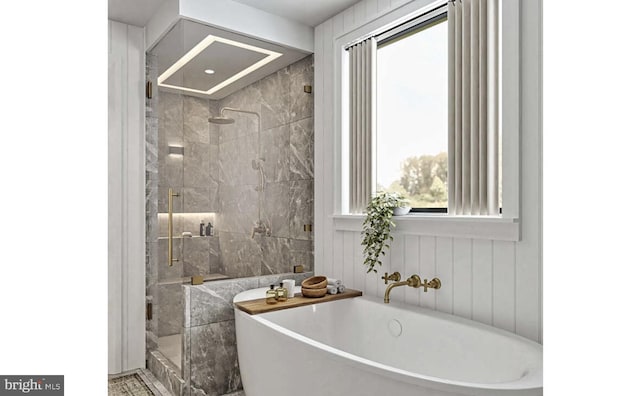 full bath with a stall shower and a freestanding bath