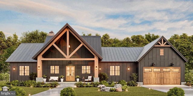 view of front of house with board and batten siding, a chimney, covered porch, and an attached garage