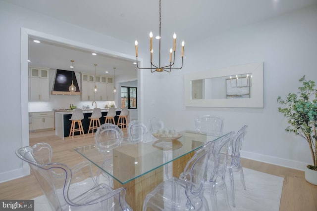 dining room with light wood-style floors, baseboards, recessed lighting, and a chandelier