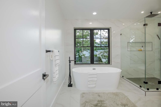 full bathroom with marble tiled flooring, a marble finish shower, a soaking tub, baseboards, and recessed lighting