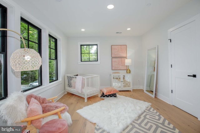 bedroom featuring light wood-type flooring, recessed lighting, and baseboards