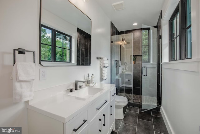 full bathroom featuring tile patterned flooring, toilet, vanity, a shower stall, and recessed lighting