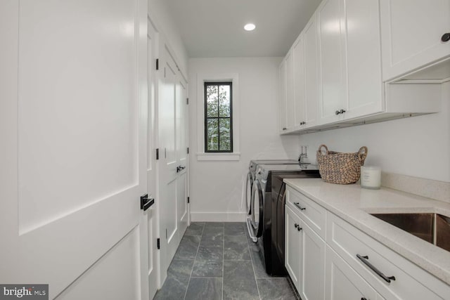washroom featuring washing machine and dryer, cabinet space, baseboards, and recessed lighting