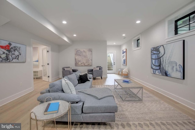 living area with wood finished floors, recessed lighting, and baseboards