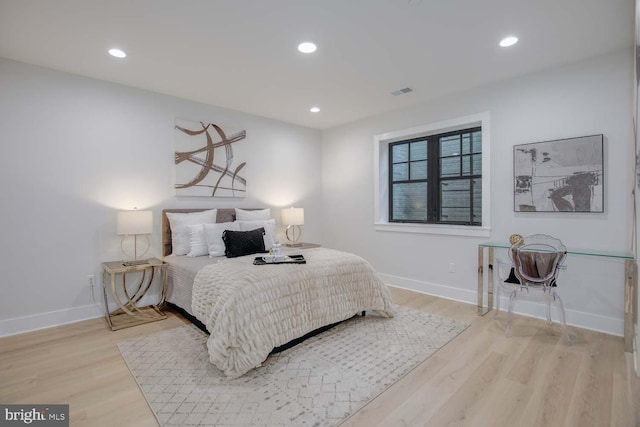 bedroom featuring wood finished floors, baseboards, and recessed lighting