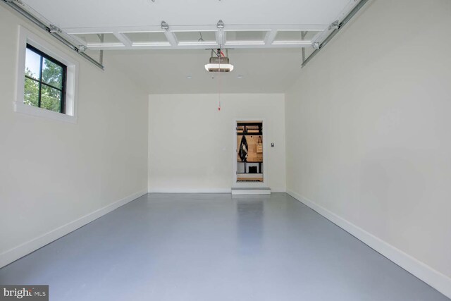 garage featuring a garage door opener and baseboards