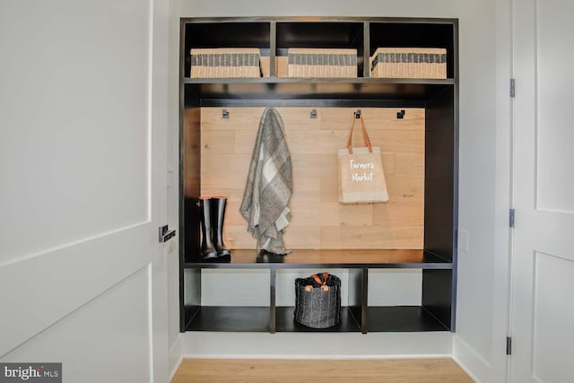 mudroom with baseboards and wood finished floors