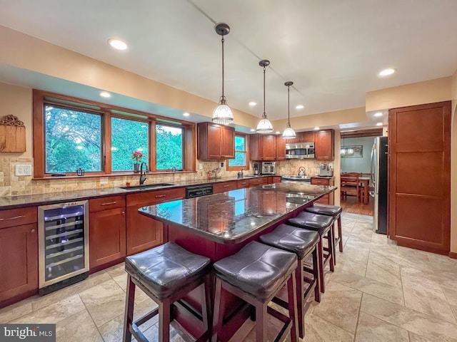 500 Newport Cir, Langhorne, PA 19053 - kitchen featuring wine cooler, appliances with stainless steel finishes, a sink, backsplash, and a kitchen bar