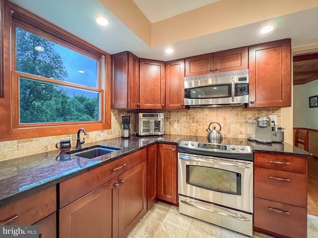 500 Newport Cir, Langhorne, PA 19053 - kitchen with stainless steel appliances, a sink, backsplash, dark stone countertops, and recessed lighting