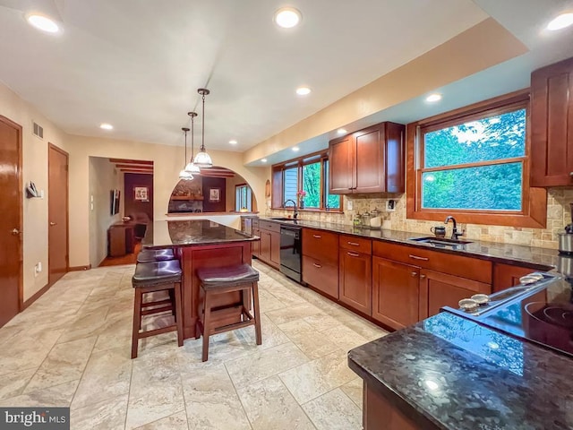 500 Newport Cir, Langhorne, PA 19053 - kitchen featuring black dishwasher, a sink, arched walkways, decorative backsplash, and a breakfast bar