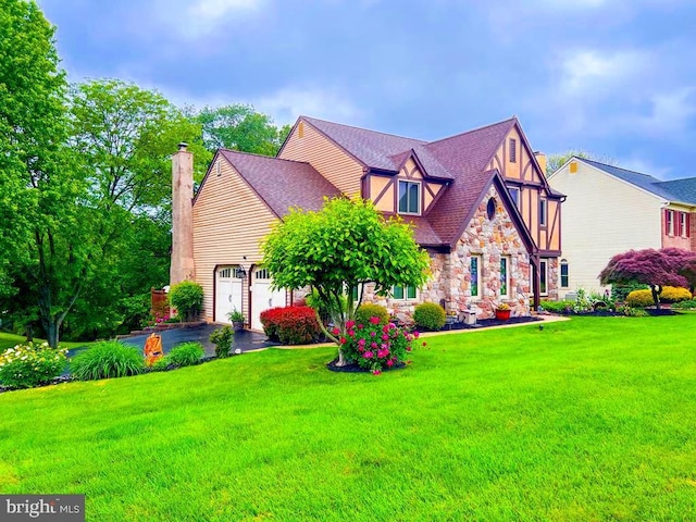 500 Newport Cir, Langhorne, PA 19053 - tudor home featuring stone siding, a front lawn, a chimney, an attached garage, and asphalt driveway