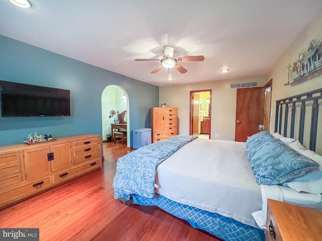 500 Newport Cir, Langhorne, PA 19053 - bedroom featuring light wood-type flooring, ensuite bath, arched walkways, recessed lighting, and a ceiling fan