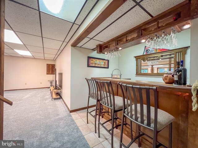 500 Newport Cir, Langhorne, PA 19053 - indoor wet bar featuring a drop ceiling, baseboards, tile patterned floors, and carpet flooring