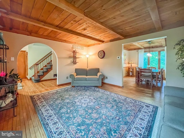 500 Newport Cir, Langhorne, PA 19053 - living room featuring wood ceiling with exposed beams, hardwood / wood-style floors, arched walkways, stairway, and baseboards