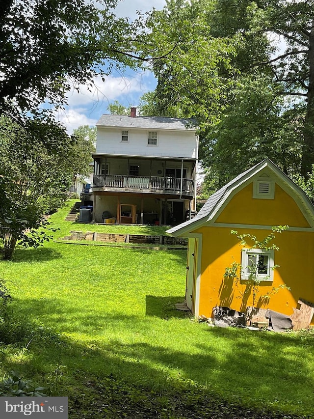 2817 Ontario Ave, Baltimore, MD 21234 - rear view of property featuring a lawn, a deck, and a chimney