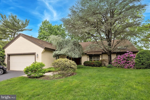 8 Fetlock Ln, Blue Bell, PA 19422 - ranch-style home featuring stucco siding, a front yard, asphalt driveway, and a garage