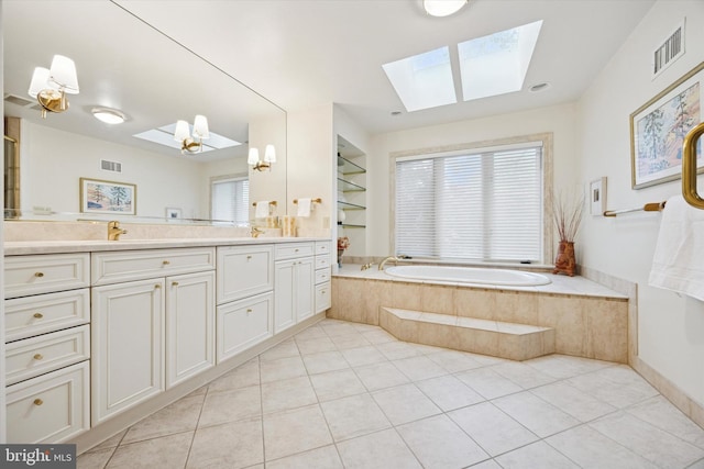 8 Fetlock Ln, Blue Bell, PA 19422 - full bathroom featuring a skylight, a garden tub, double vanity, and tile patterned flooring