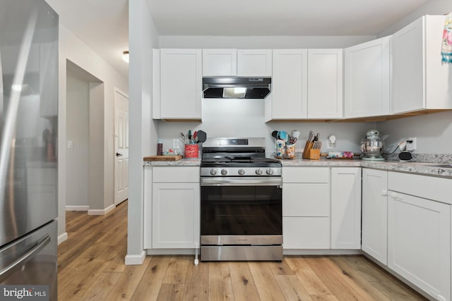 301 Heine Ave, Woodbine, NJ 08270 - kitchen featuring stainless steel appliances, under cabinet range hood, light wood-style floors, white cabinetry, and baseboards