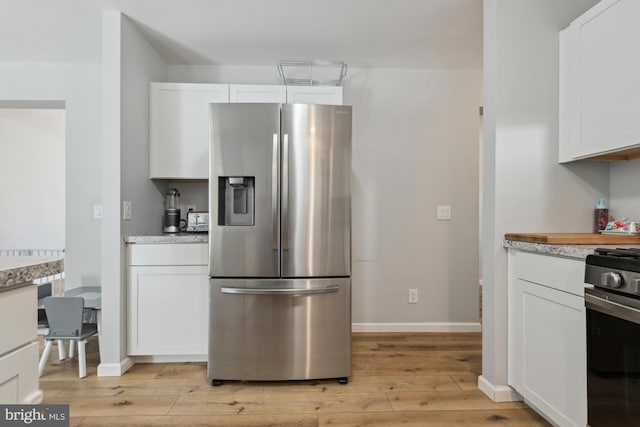 301 Heine Ave, Woodbine, NJ 08270 - kitchen featuring appliances with stainless steel finishes, light wood-style floors, white cabinetry, light countertops, and baseboards