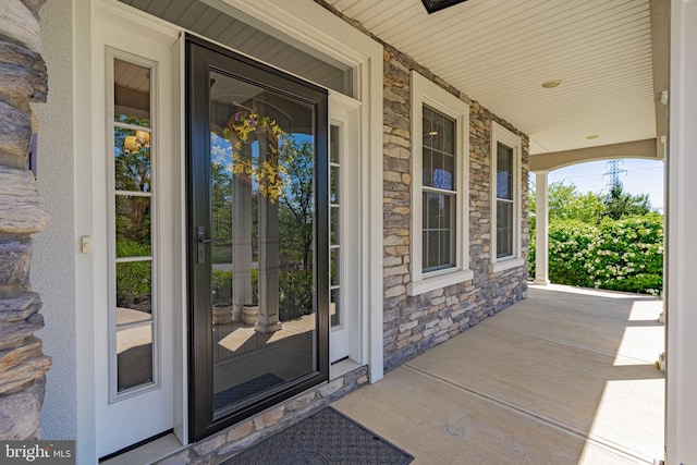 232 Cobblestone Ln, Bethlehem, PA 18020 - doorway to property featuring stone siding and covered porch
