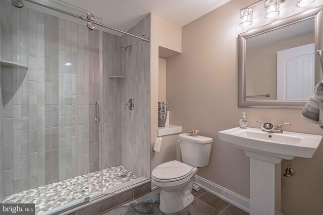 232 Cobblestone Ln, Bethlehem, PA 18020 - full bathroom with tile patterned flooring, toilet, a stall shower, and baseboards
