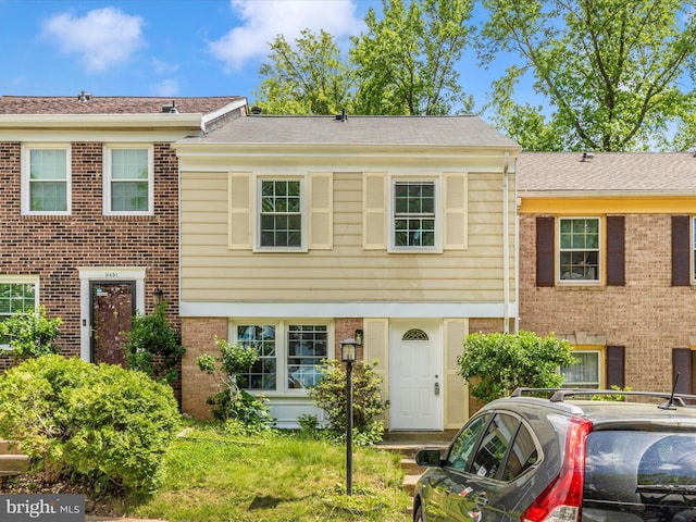 view of property featuring brick siding