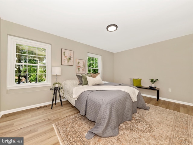 bedroom with wood finished floors and baseboards