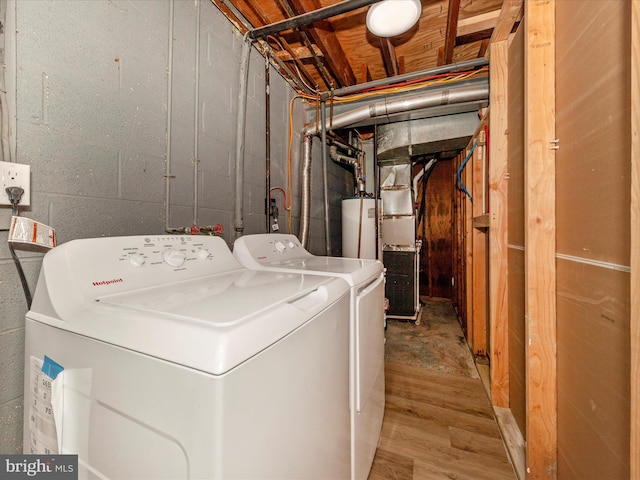 laundry area with washer and clothes dryer and wood finished floors