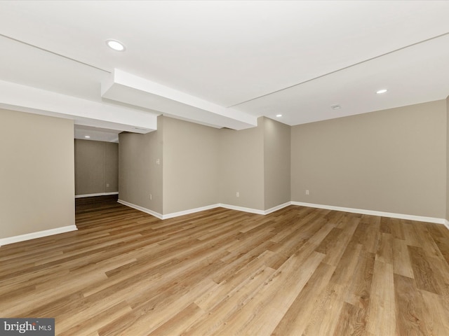 finished basement with light wood finished floors, baseboards, and recessed lighting