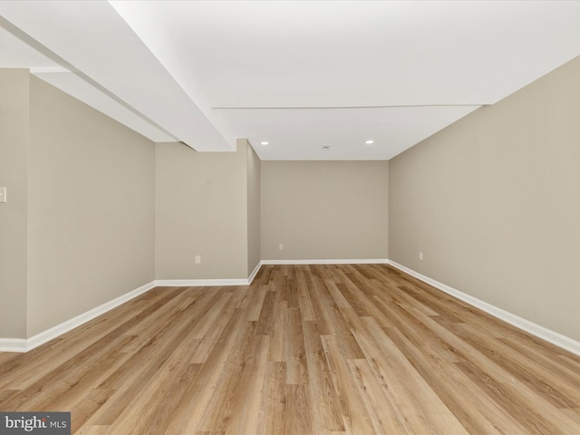 unfurnished room with light wood finished floors, baseboards, and recessed lighting