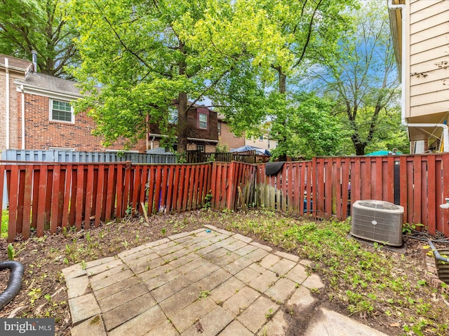 view of patio with central air condition unit and fence