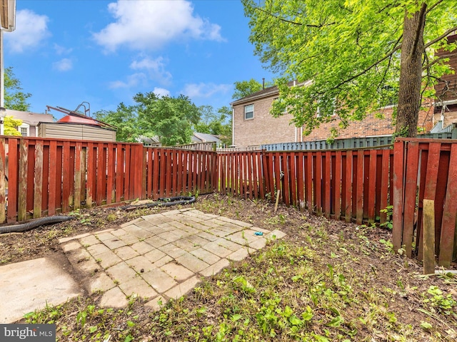 fenced backyard with a patio