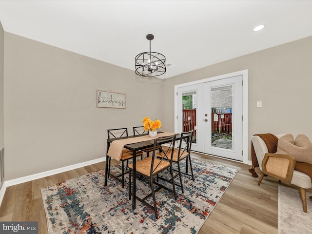dining area with french doors, wood finished floors, a chandelier, baseboards, and recessed lighting