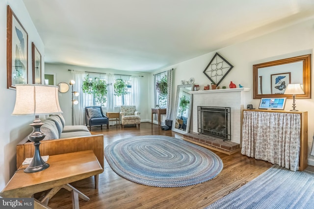 1381 Burmont Rd, Drexel Hill, PA 19026 - living area featuring plenty of natural light, wood finished floors, and a brick fireplace