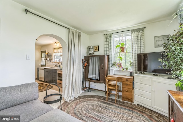 1381 Burmont Rd, Drexel Hill, PA 19026 - office area featuring arched walkways, a sink, and light tile patterned flooring